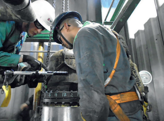 Technicians servicing bolted equipment